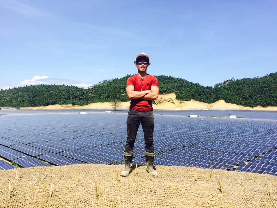 An image of me with solar panels at the background